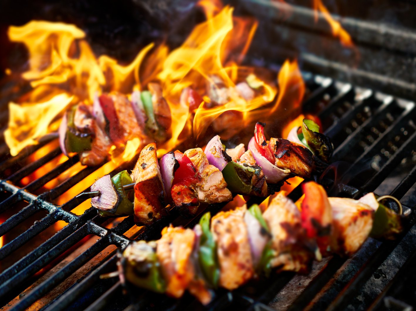 Grilling Chicken Kabobs on Flaming Grill