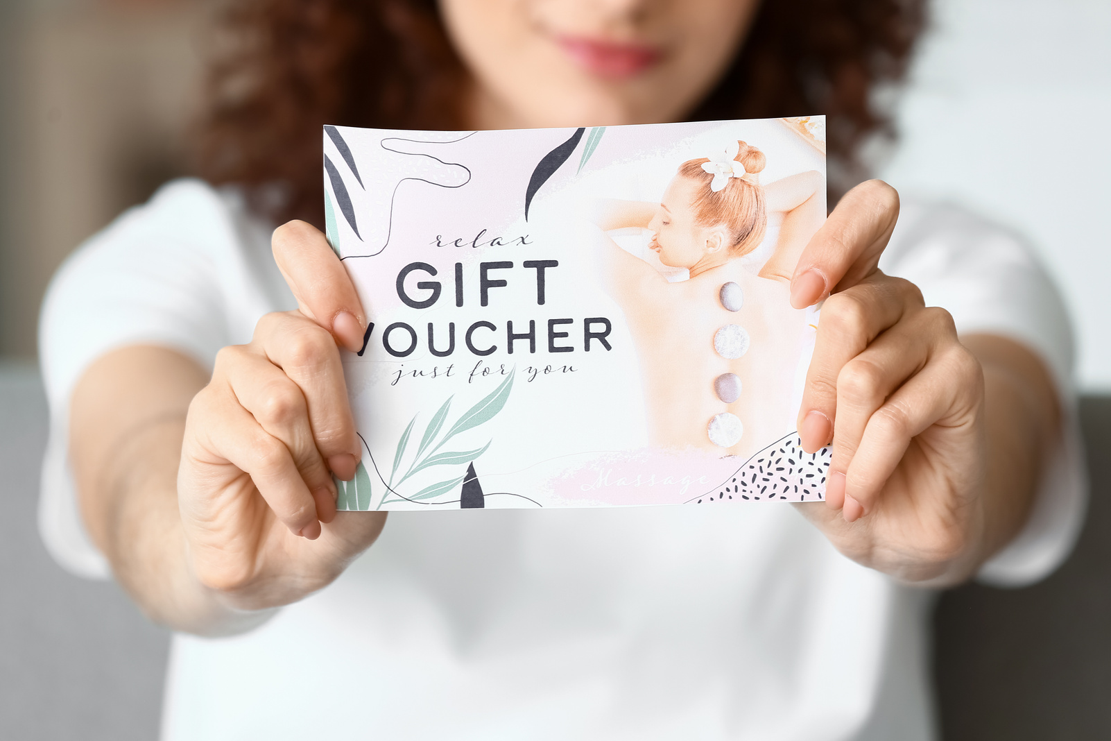 Young Woman with Gift Voucher at Home, Closeup